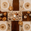 Arial view of a dinning room table set for a special dinner and decorated with pumpkins.